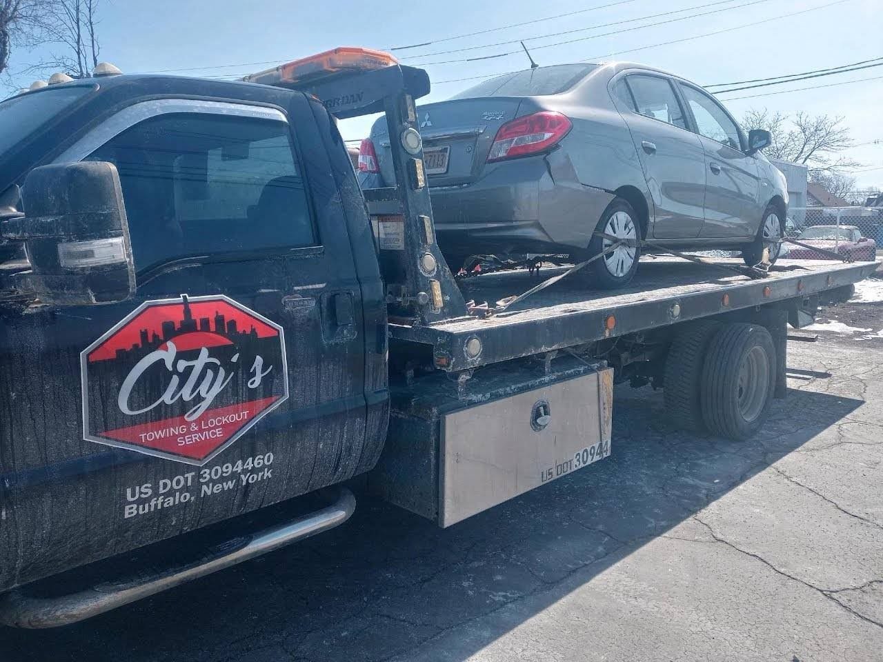 City's Towing branded flatbed truck — Buffalo NY